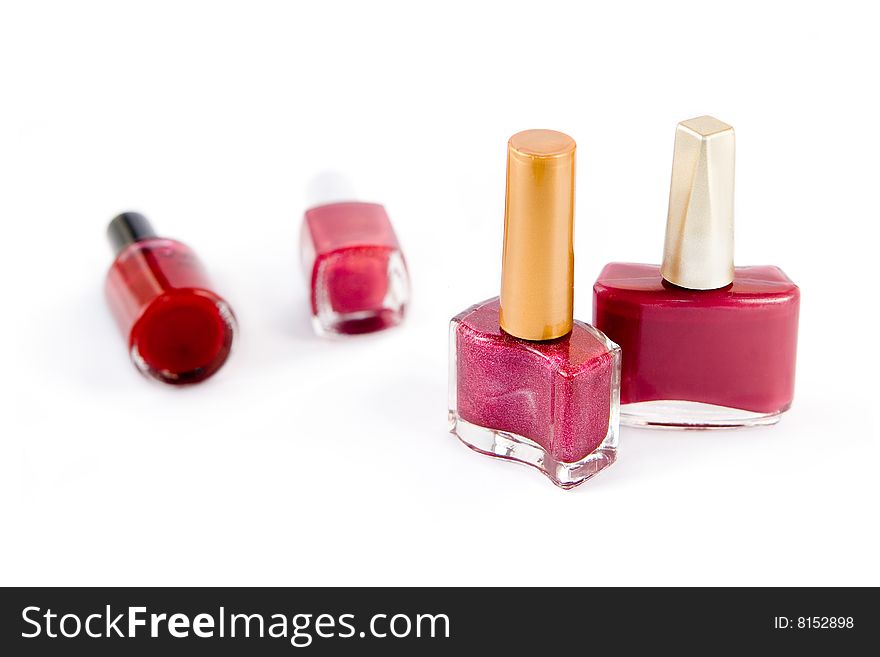 Group of pink and red nail polish on white background