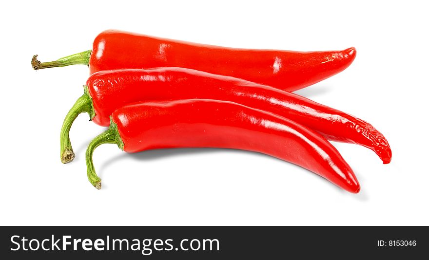 Big red hot chili peppers isolated over white