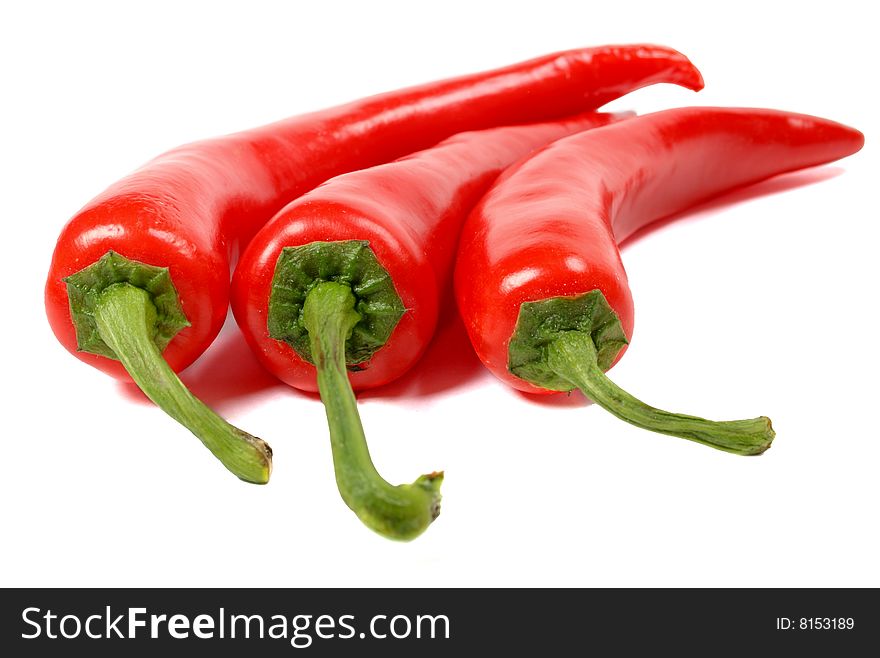 Big red hot chili peppers isolated over white