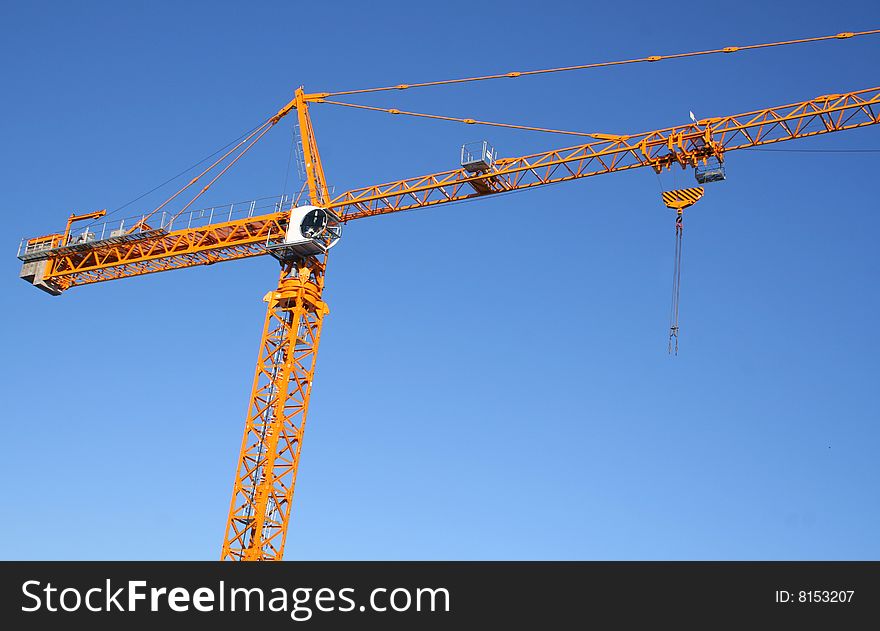 Lifting crane on dark blue