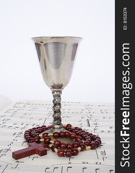 Religious items on a music sheet in white background. Religious items on a music sheet in white background
