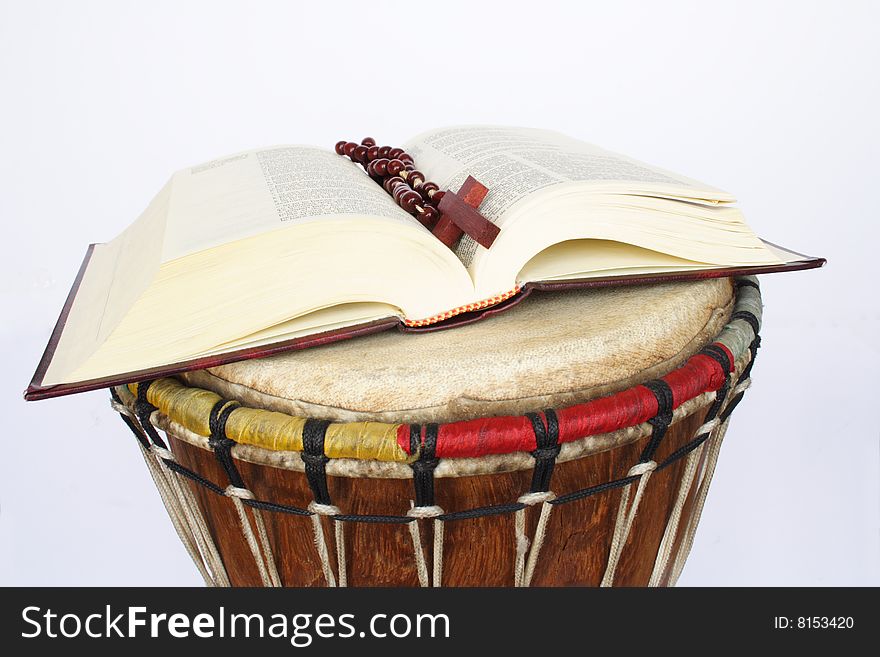 Bible and rosary on drum in white background. Bible and rosary on drum in white background