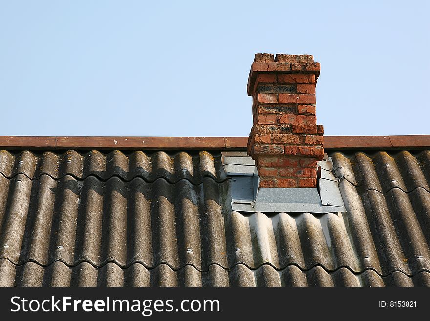 Brick pipe on a roof of the rural house