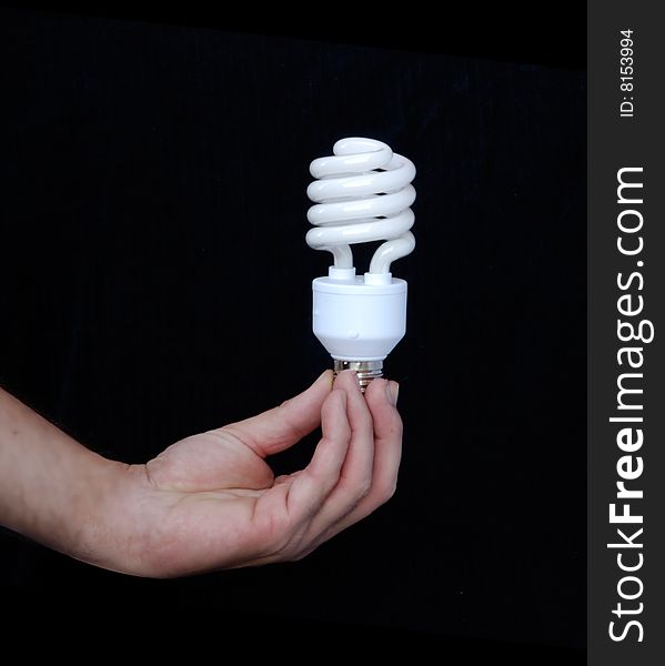 Hand holding an energy-saving lamp. Hand holding an energy-saving lamp