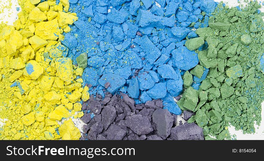 Colored grainy crushed chalk's textured background. Blue, yellow, green and purple