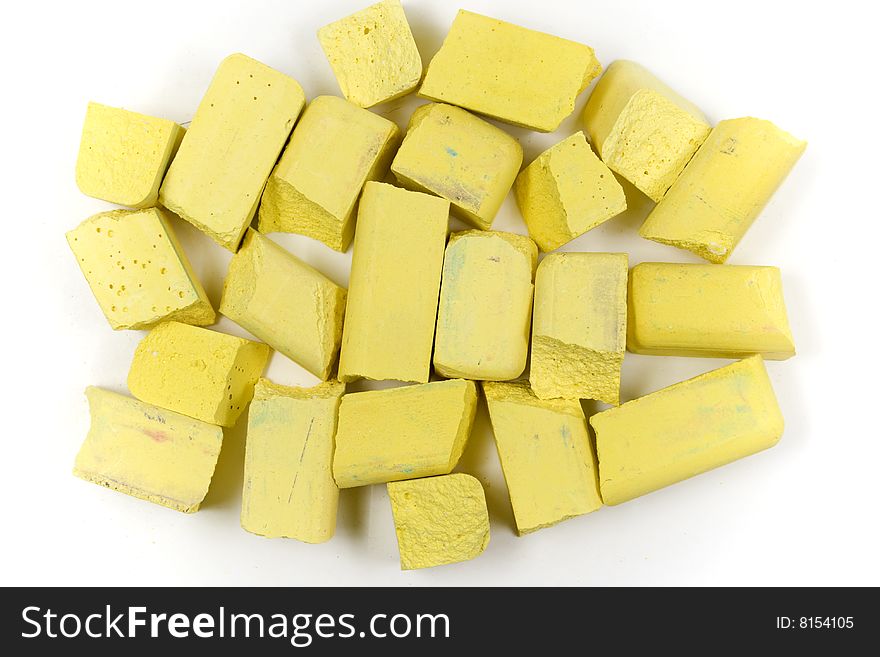 Small group of yellow chalks on white