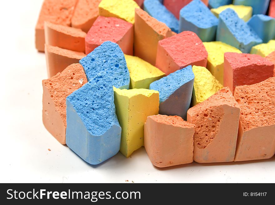 Set of mixed colored crushed childrens chalks in vertical. Set of mixed colored crushed childrens chalks in vertical
