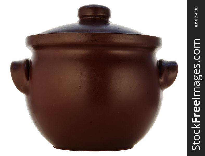 Brown pot from heatproof ceramics with a spoon. Brown pot from heatproof ceramics with a spoon
