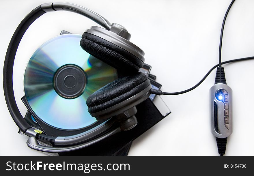 Headphones on the Pile of Disks against the Light Background