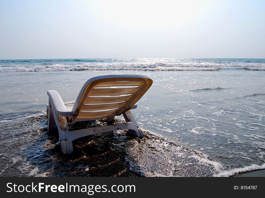 Relaxing scene with sunbed in the ocean