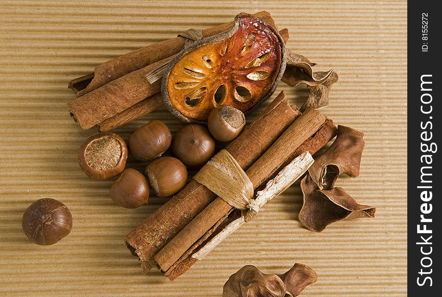 Cinnamon dried orange and hazelnut composition closeup. Cinnamon dried orange and hazelnut composition closeup