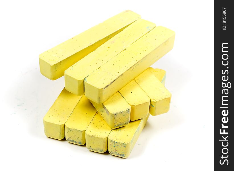 Stacked group yellow chalk on white background. Stacked group yellow chalk on white background