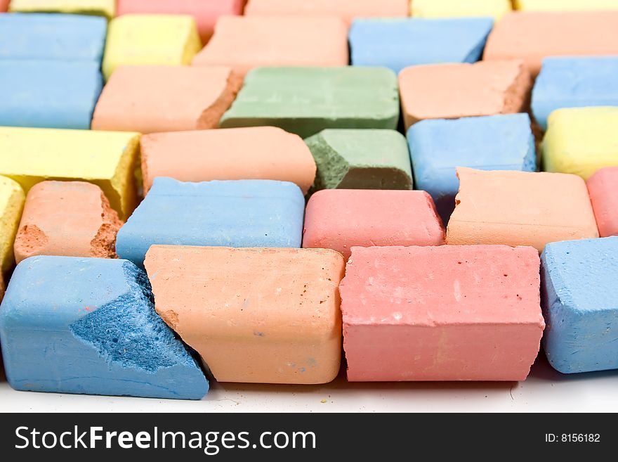 Set of mixed colored crushed childrens chalks, stacked in horizontal rows. Set of mixed colored crushed childrens chalks, stacked in horizontal rows