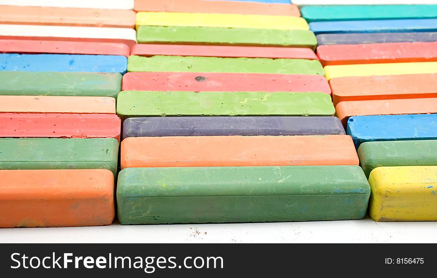 Set of colored chalk stacked in rows