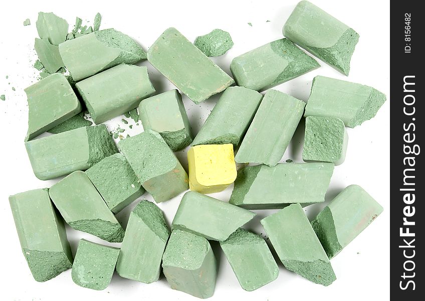 Small group of green chalks with one yellow