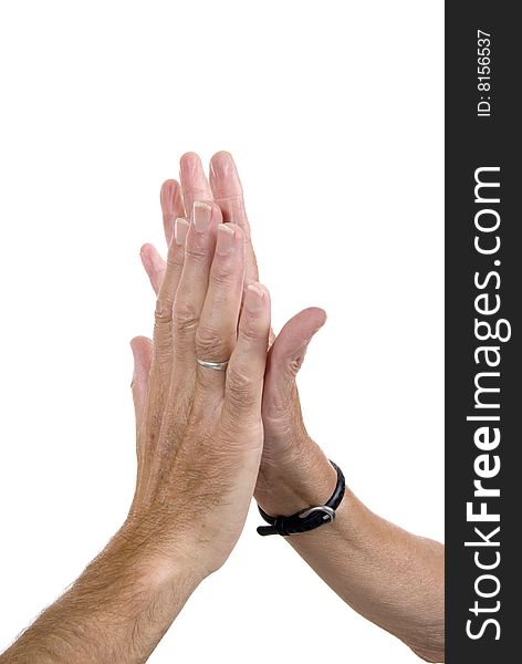 Male hand slapping female hand in 'high fives' gesture of congratulation. White background.