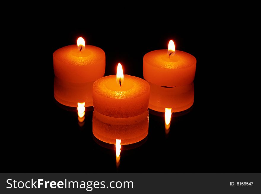 Candles stand on a mirror