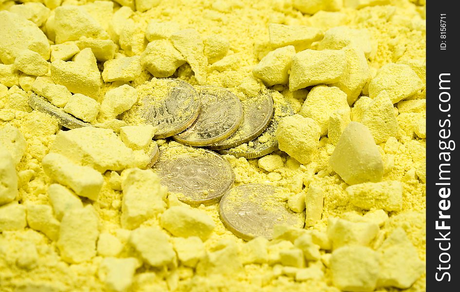 Several coins in yellow crushed chalk background