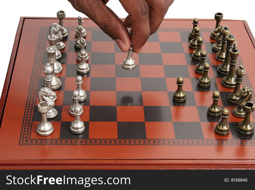 African American male hand on chess board. African American male hand on chess board.