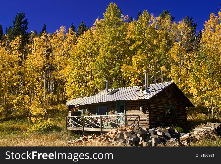 A country cabin in Colorado in Autumn with Aspen trees. A country cabin in Colorado in Autumn with Aspen trees