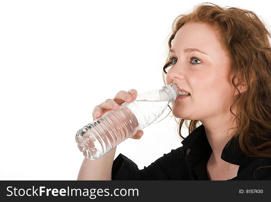 Young woman drinking mineral water directly from the bottle, isolated on white background