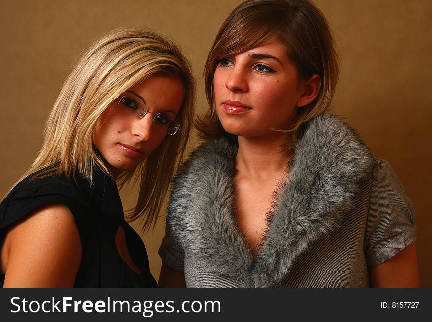 Two women, elegant. best friends in the soft light of a studio. Two women, elegant. best friends in the soft light of a studio