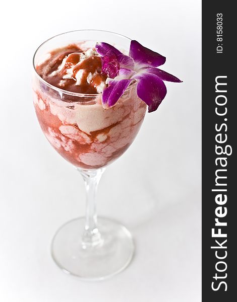 Strawberry Vanilla Parfait on a glass with a flower