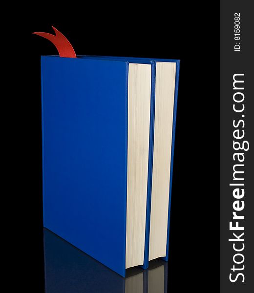Two blue books isolated on black background.