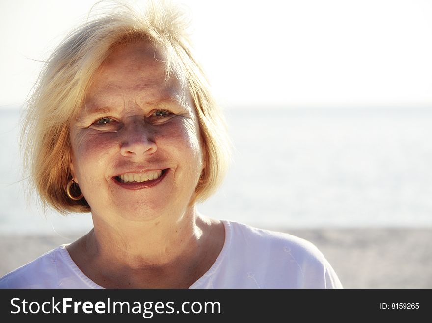 Photo of a happy senior on the beach. Photo of a happy senior on the beach