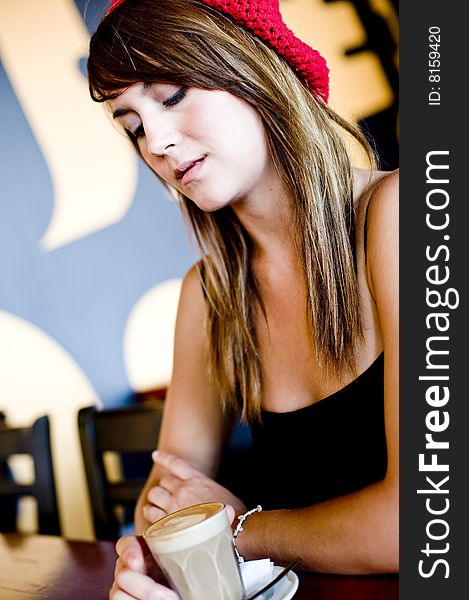 A beautiful young woman having lucnh in a cafe