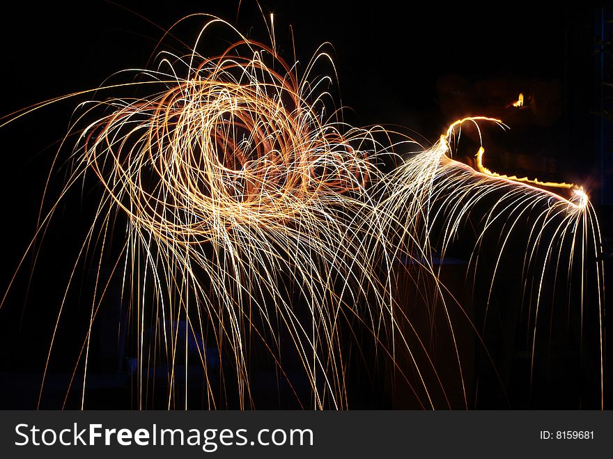 Rotating the burning stick to make the fireworks looks like a flower