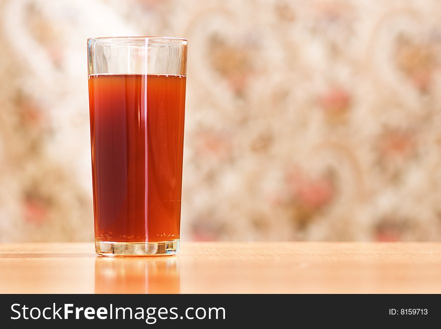 Glass with carbonated drink on blurred background