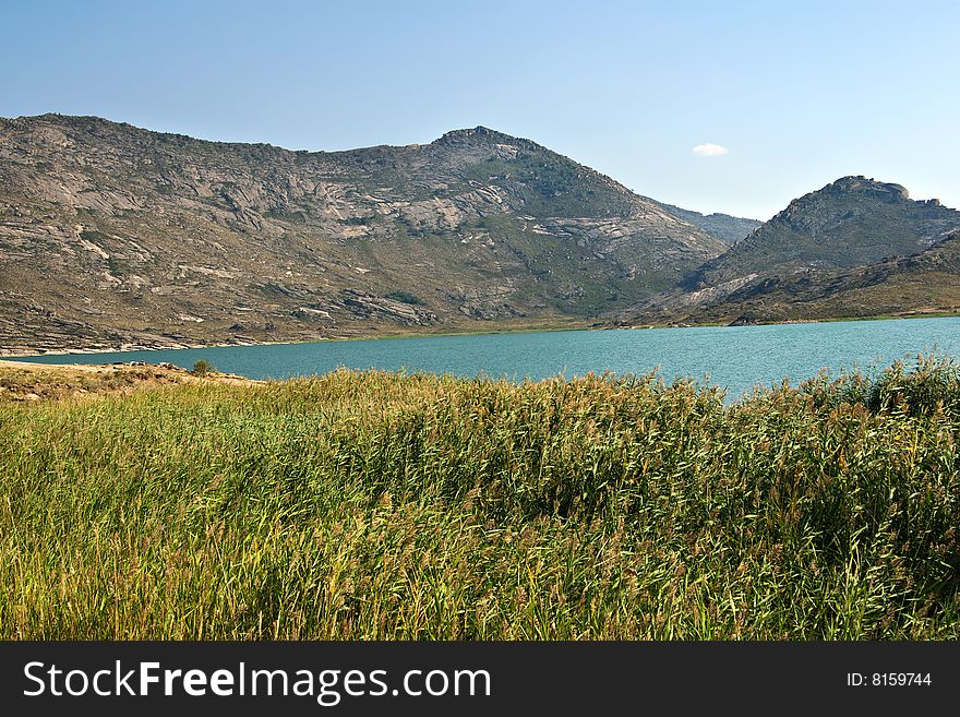 Lake and mountains landscape with blue sky