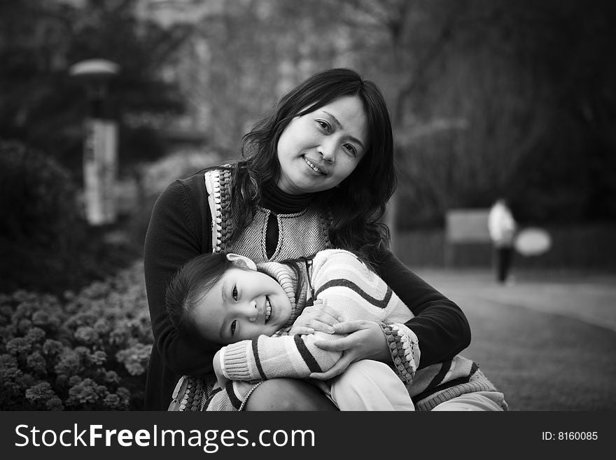 Mother and 8 year old daughter in a city park. Mother and 8 year old daughter in a city park.