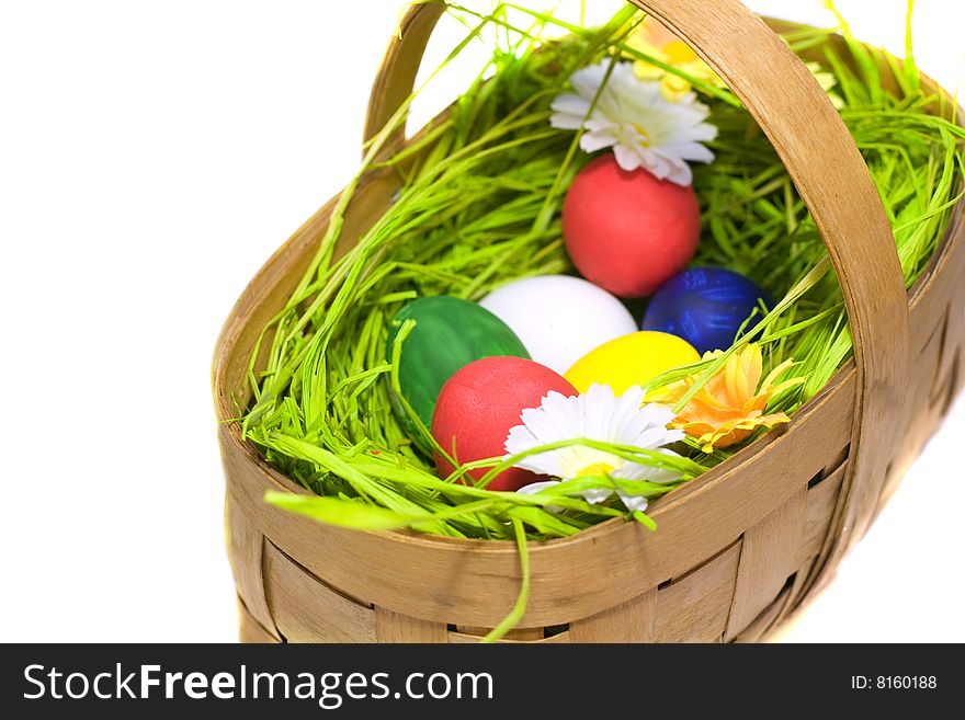 Easter eggs in the basket on white background