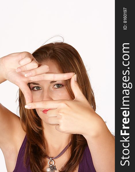 Brunette with slim hands holding square infront of face. Brunette with slim hands holding square infront of face