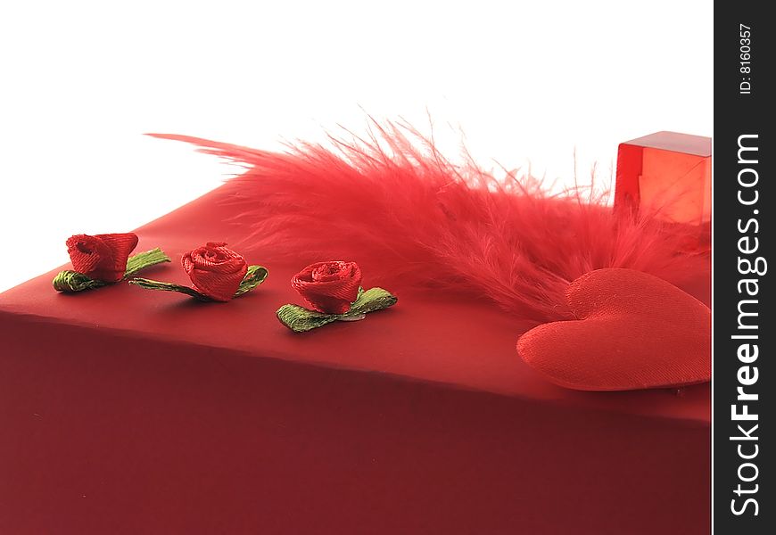 Part of gift packing with decorative roses and a feather. Part of gift packing with decorative roses and a feather