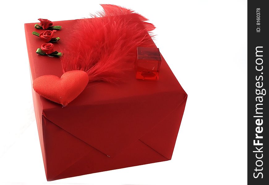 Beautiful red gift packing with small Ñ€Ð¾Ð·Ð¾Ñ‡ÐºÐ°Ð¼Ð¸ and a feather. Beautiful red gift packing with small Ñ€Ð¾Ð·Ð¾Ñ‡ÐºÐ°Ð¼Ð¸ and a feather