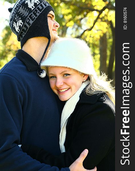 Two nice romantic young caucasian couple hugging in the park. Two nice romantic young caucasian couple hugging in the park