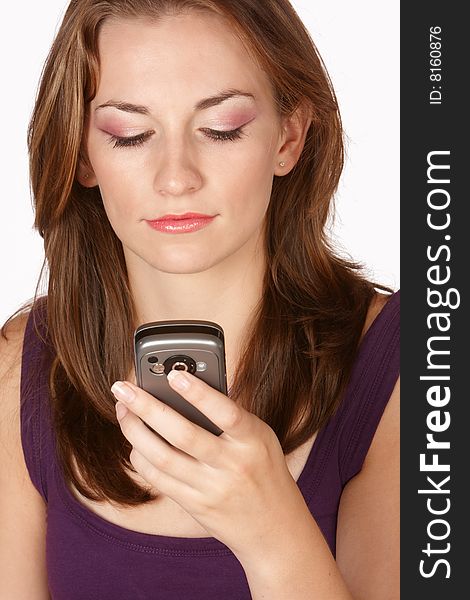 Young brunette with pink makeup looking at cellphone screen