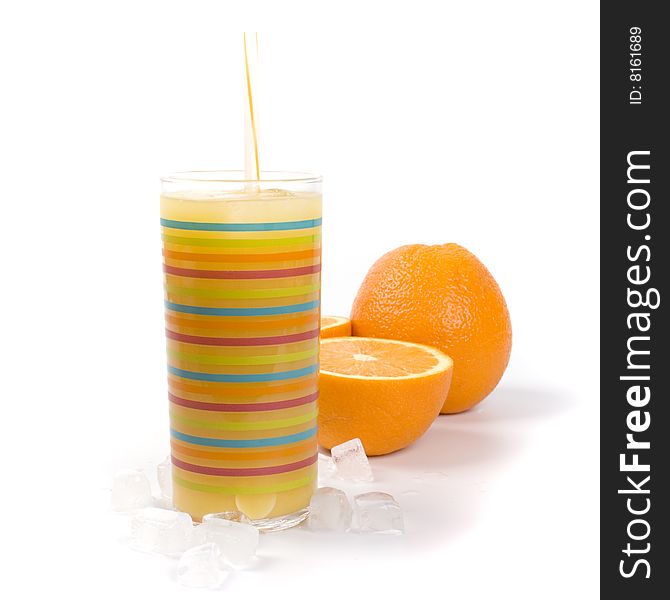 Oranges, ice and juice in glass on white