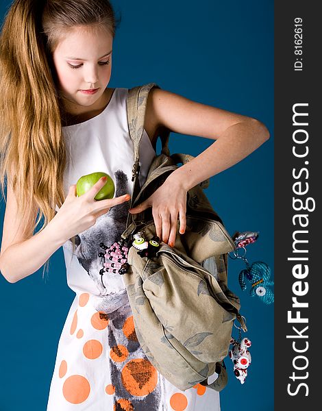 Young cute schoolgirl posing with an apple. Young cute schoolgirl posing with an apple