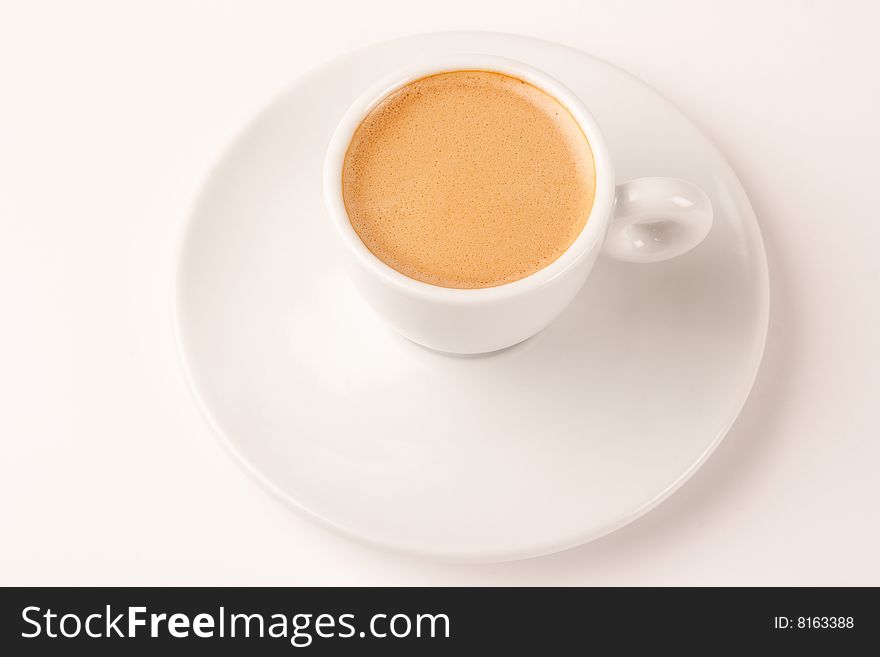 Espresso in a white cup isolated on white. Espresso in a white cup isolated on white