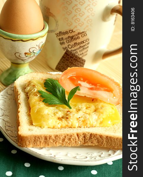 Breakfast, toast with fused cheese and slice of a tomato