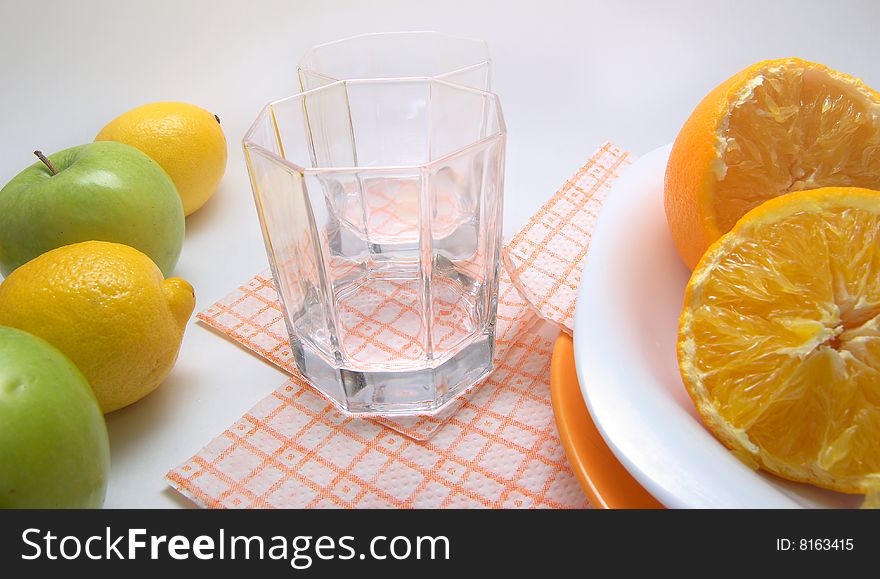 Fresh seasonal fruit, apples, bananas,  orange and glass fruit juice on reflective underground