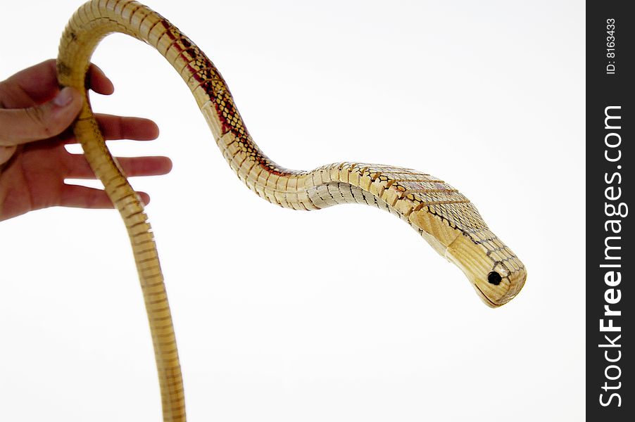 A wooden snake with a white background