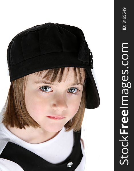 Adorable young girl in black hat turned sideways. Adorable young girl in black hat turned sideways