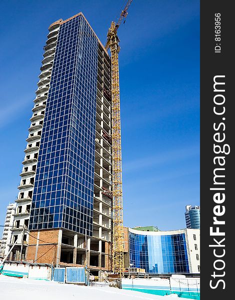 Construction of office building, on a background of blue sky