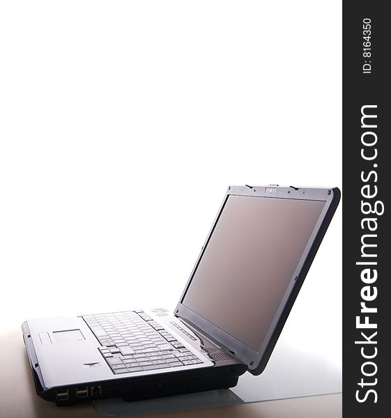 A laptop Computer on a table with white background. A laptop Computer on a table with white background.