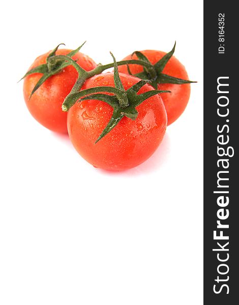 Macroshot of a bunch of tomatoes with drops of water. Isolated over white background. Lot of copyspace. Macroshot of a bunch of tomatoes with drops of water. Isolated over white background. Lot of copyspace.